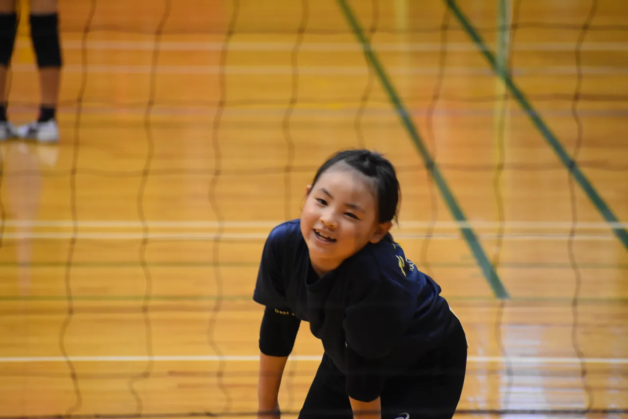 レシーブの構えで笑顔の選手